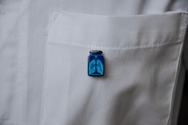 MedArtz Heart XL Pin on a white coat, front close view.