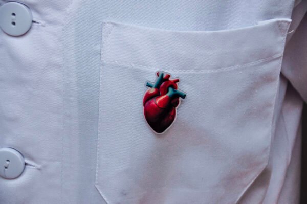 MedArtz Heart XL Pin on a white coat, front close view.