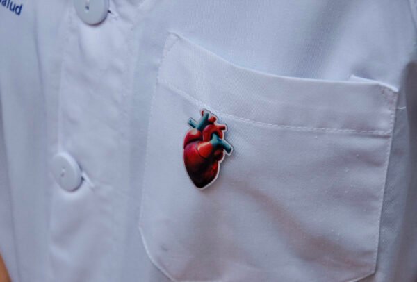 MedArtz Heart XL Pin on a white coat, lateral close view.