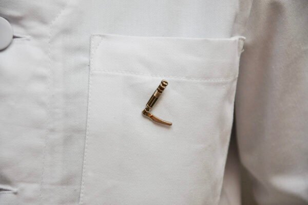 MedArtz Laryngoscope Pin on a white lab coat